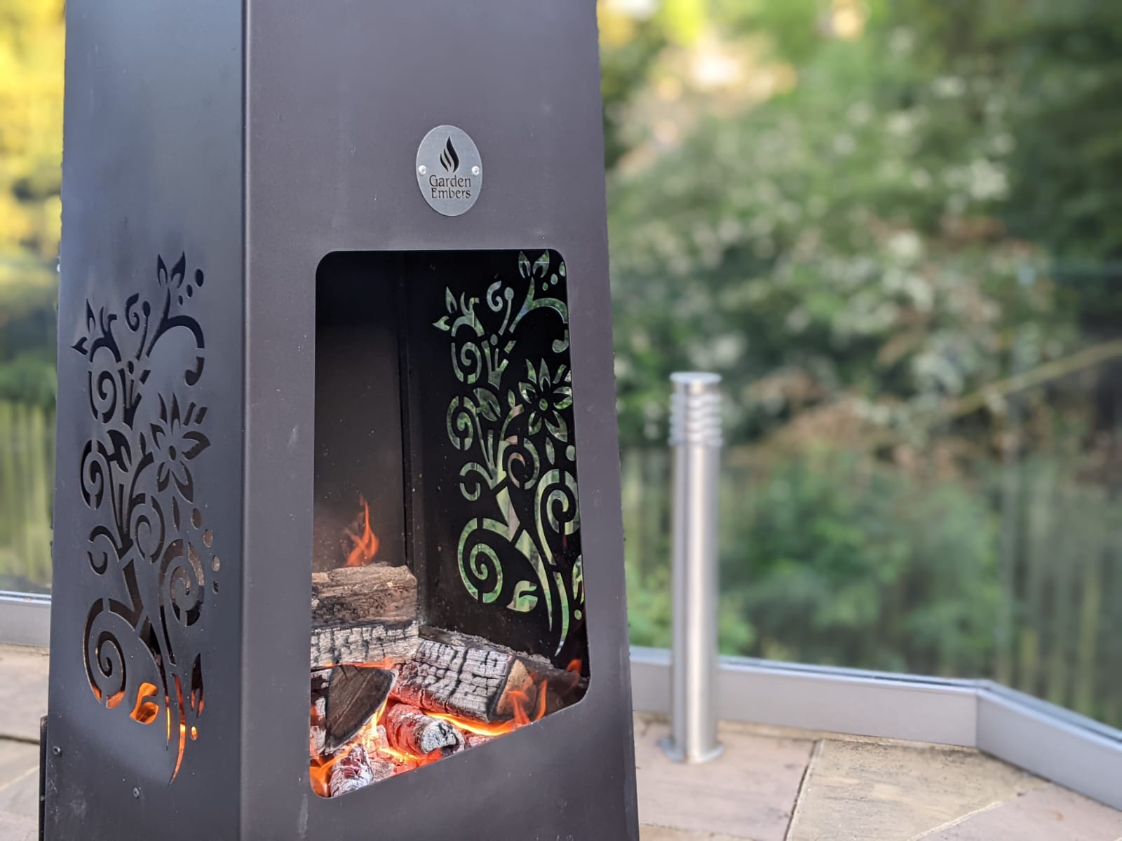 Luxury Metal Chiminea by Garden Embers close up with trees in back ground